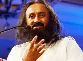 A closeup of Gurudev speaking in front of a microphone